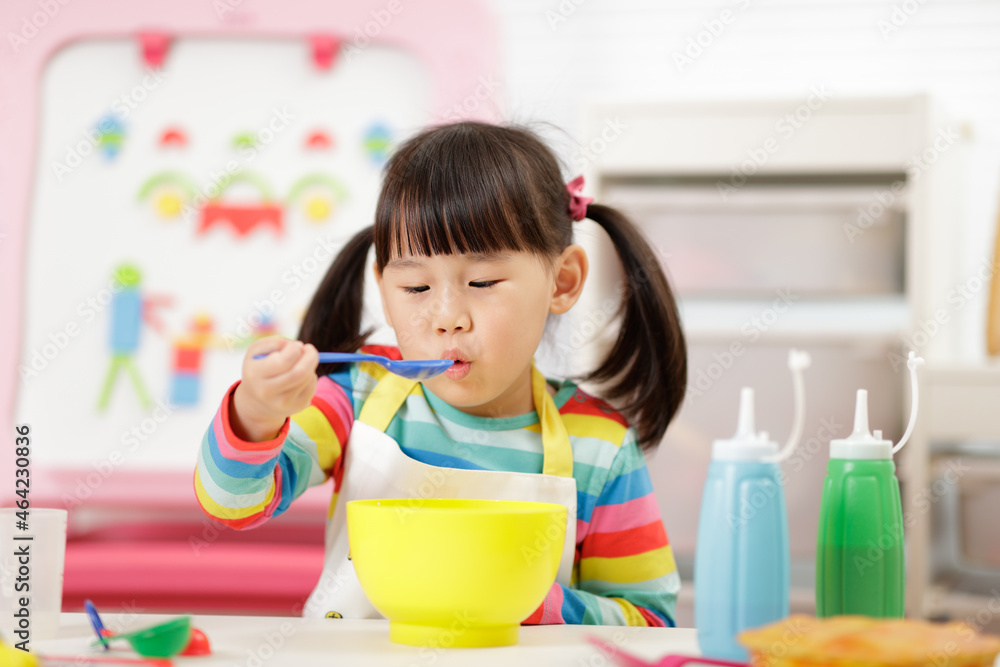 young girl pretend playing food preparing at home young girl pretend playing food preparing at home