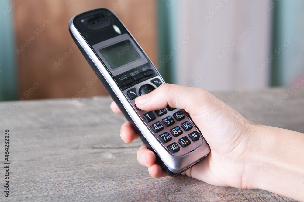 woman dials the number on home phone woman dials the number on home phone