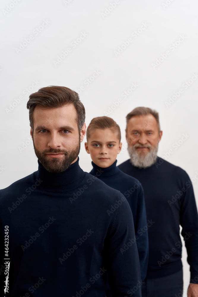 Vertical shot of three generations of men together Vertical shot of three generations of men together