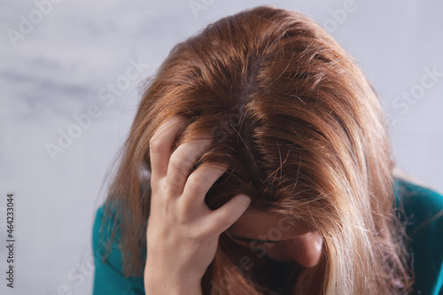 a young woman has an itchy head photo