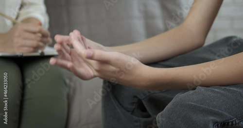 Therapist help in quarantine. A woman therapist speak with child and write her problems in the notebook. photo