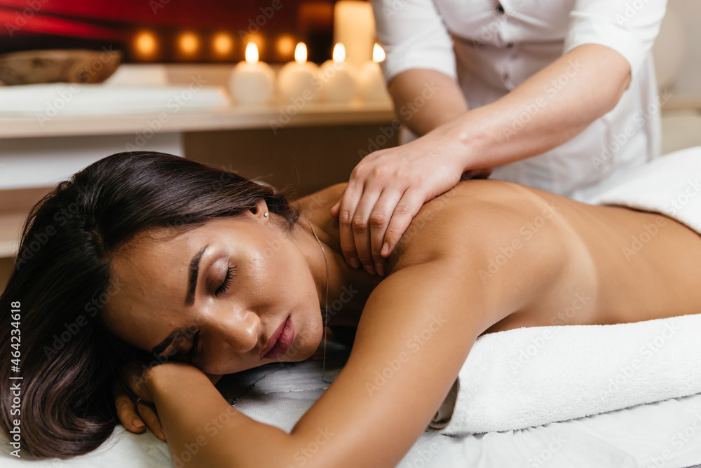 Obraz premium Young woman on massage table in beauty spa salon