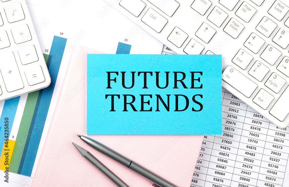 FUTURE TRENDS text on blue sticker on chart with calculator and keyboard FUTURE TRENDS text on blue sticker on chart with calculator and keyboard