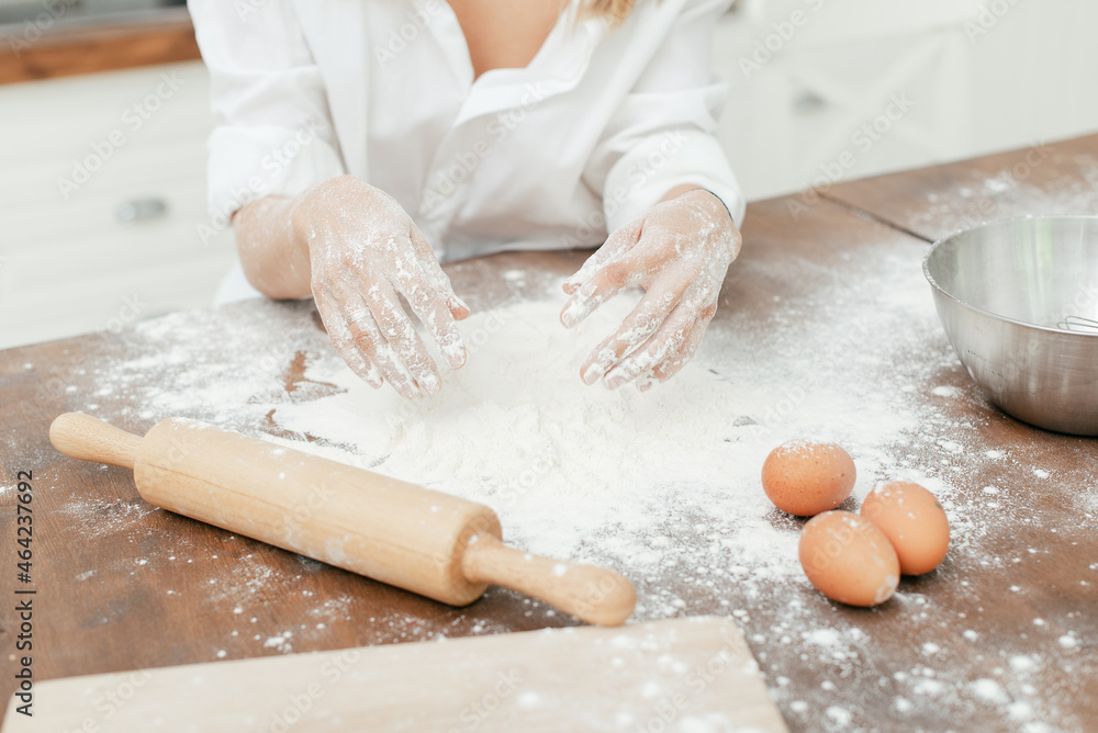 girl in the kitchen sculpts dough hands and table in white flour girl in the kitchen sculpts dough hands and table in white flour