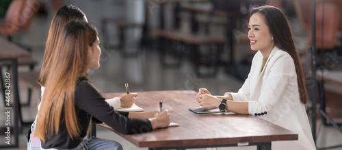 College instructors and advisors meet female college students to advise their research study. Education Concept Stock Photo photo