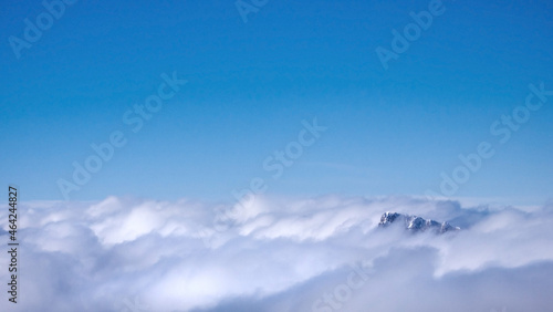 Sunny day on dolomites, a peak above the clouds © Alessandro