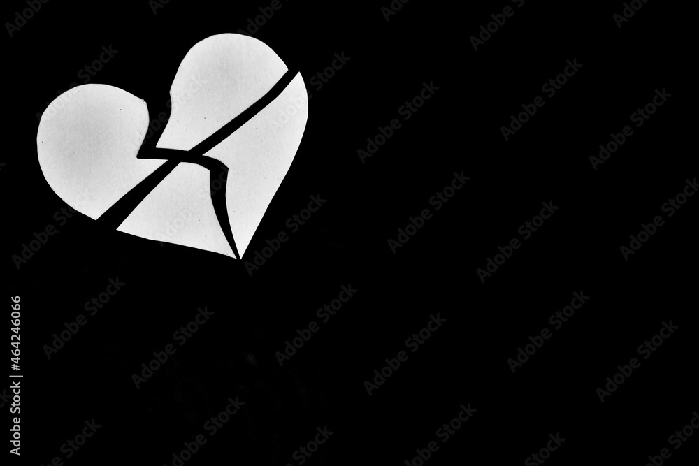 isolated broken heart on dark background. Feeling sad, Lonely. Hate. Unhappy. 