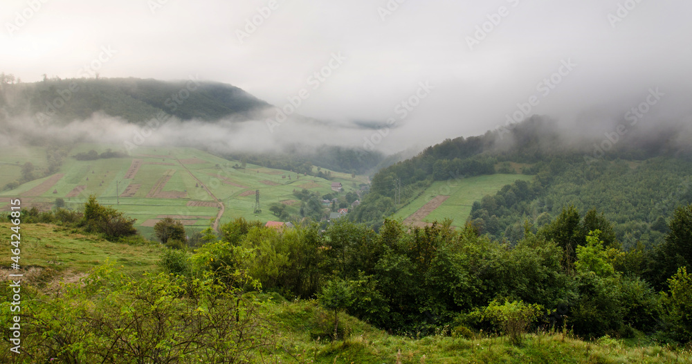 dramatic landscape. morning in the mountains. fog in the background. early autumn landscape