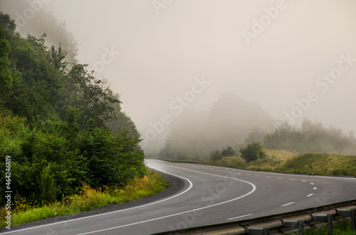 dramatic landscape. morning in the mountains. fog in the background. landscape of early autumn. road to the mountains