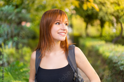 Young pretty redhead woman at outdoors with happy expression © luismolinero