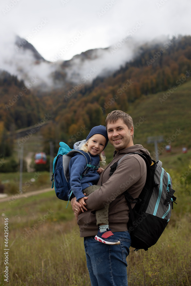 Father daughter little girl hiking mountains autumn day. Family adventure