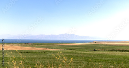 views of the sea  steppe plains and mountain silhouettes in the distance.