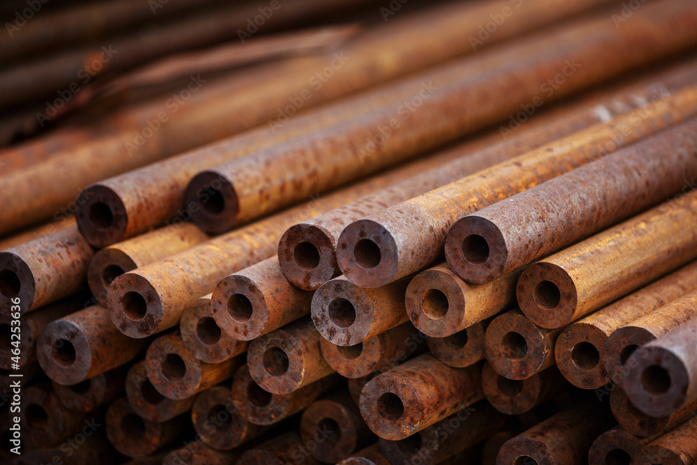 Many small-diameter metal pipes for gasification and construction lie in a stack in an open warehouse on the street. Solid industrial background for the supplier of metal pipes. New products. Many small-diameter metal pipes for gasification and construction lie in a stack in an open warehouse on the street. Solid industrial background for the supplier of metal pipes. New products.