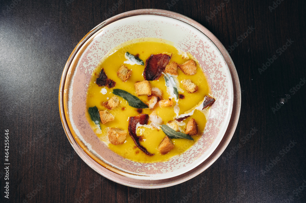 Tasty pumpkin cream soup with prawns and croutons. Tasty pumpkin cream soup with prawns and croutons.