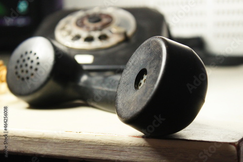 very old black phone with dial