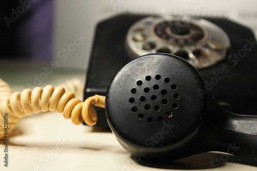 very old black phone with dial