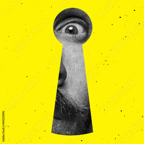 Фотография Contemporary art collage of man looking through the keyhole isolated over yellow