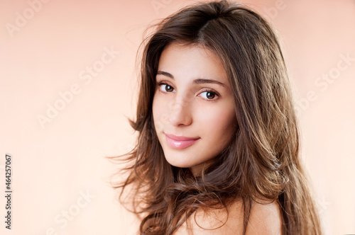 Gorgeous Hair. Beauty Fashion Model Woman with Long and Healthy Brown Hair. Brunette Girl with long hair smiling.