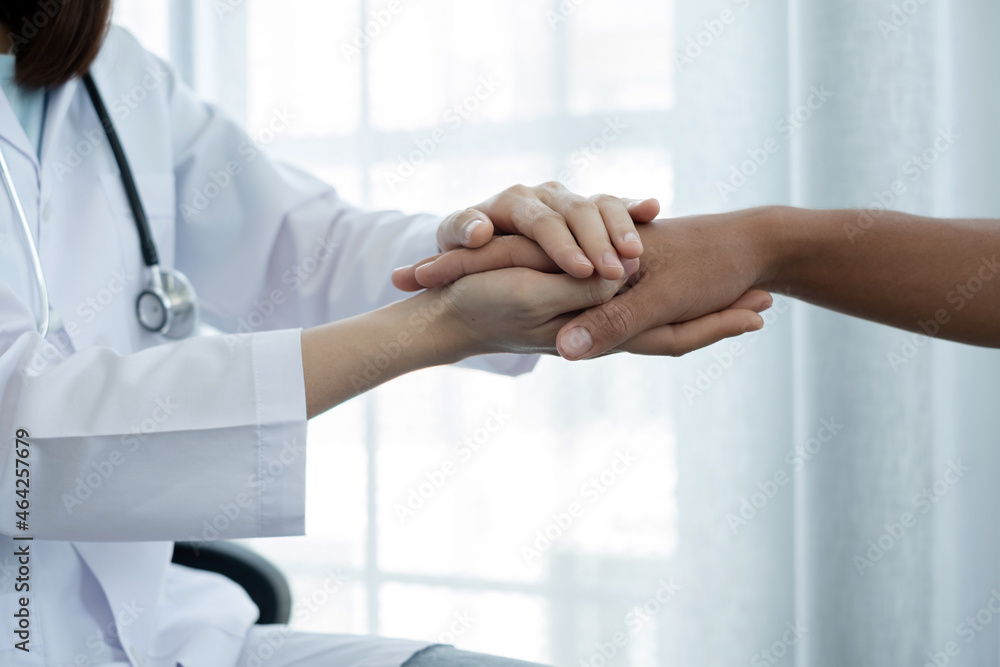 The female doctor uses a friendly hand to hold the patient's hand to give confidence and show care about health care. Medical concepts and good health The female doctor uses a friendly hand to hold the patient's hand to give confidence and show care about health care. Medical concepts and good health