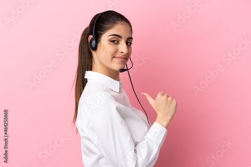 Obraz na płótnie Young telemarketer over isolated background proud and self-satisfied
