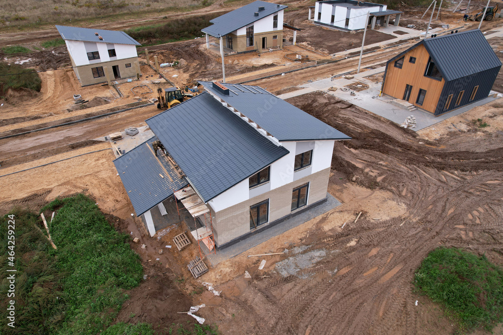 Building a country house of expanded-clay concrete blocks. Unfinished private home of ceramsite concrete blocks on a construction site.Construction work and laying bricks and roof. Suburb houses.