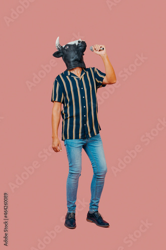 man with a cow mask speaks into a microphone