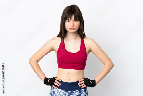 Young sport woman isolated on white background posing with arms at hip © luismolinero