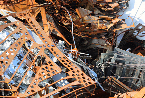 pile of rusted ferrous scrap in a landfill by a foundry photo