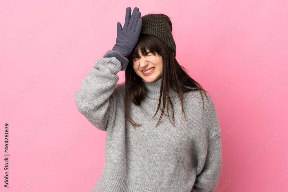 Teenager Ukrainian girl with winter hat isolated on white background having doubts with confuse face expression Teenager Ukrainian girl with winter hat isolated on white background having doubts with confuse face expression