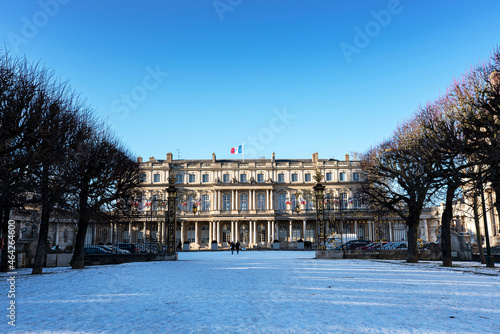 Place de la Carriere at french Nancy city covered by the snow with strolling pedestrians and Government palace with french flags on the top. photo