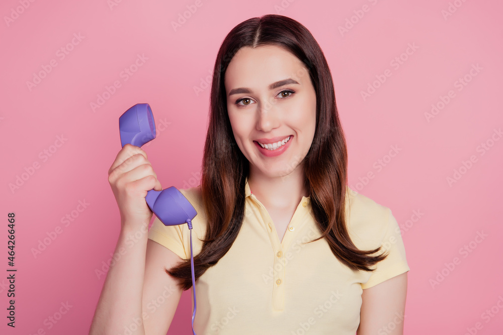 Photo of cheerful positive lady hold telephone make landline call on pink background Photo of cheerful positive lady hold telephone make landline call on pink background