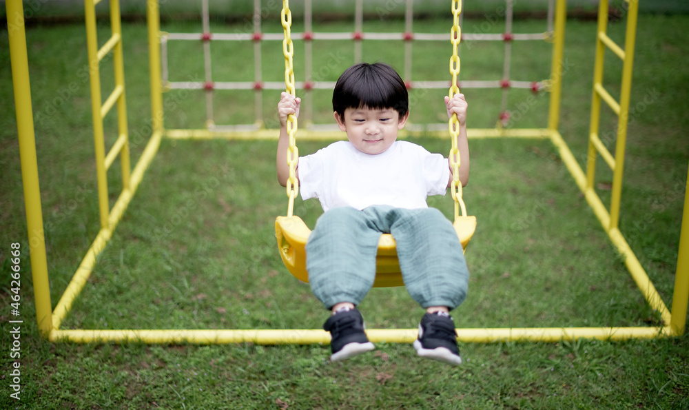 Little asian boy swing on playground Little asian boy swing on playground