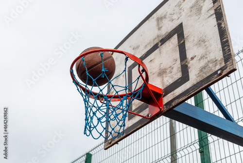 The basketball ball flies into the basket.