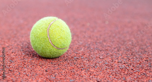 Tennis ball on the court. © schankz