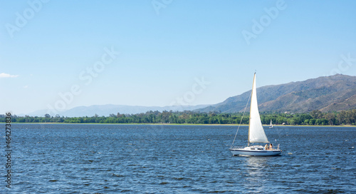 sailboats in lake san roque with calm water