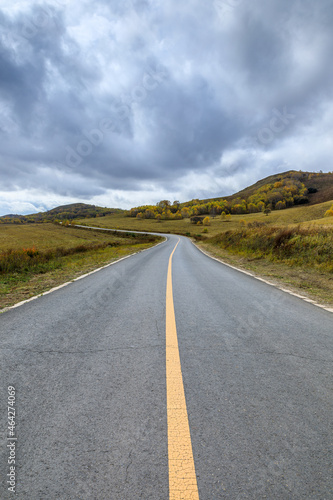 Empty asphalt road pavement and sky clouds on a cloudy day.