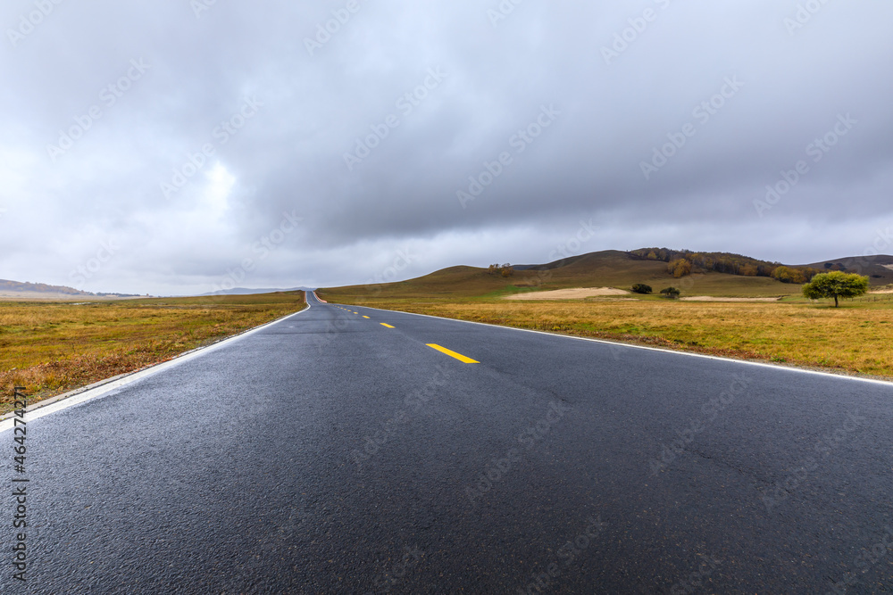 Empty asphalt road pavement and sky clouds on a cloudy day.Road ground scene after rain.