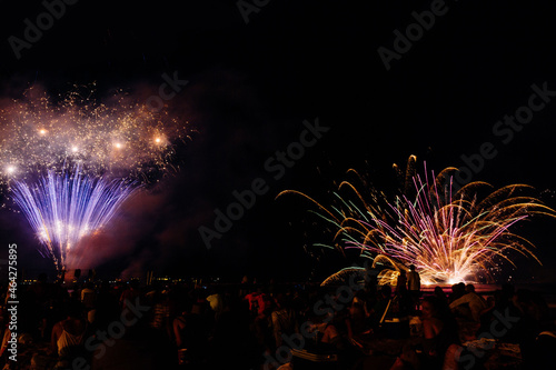 Sky with colorful firework blast launched by the beach
