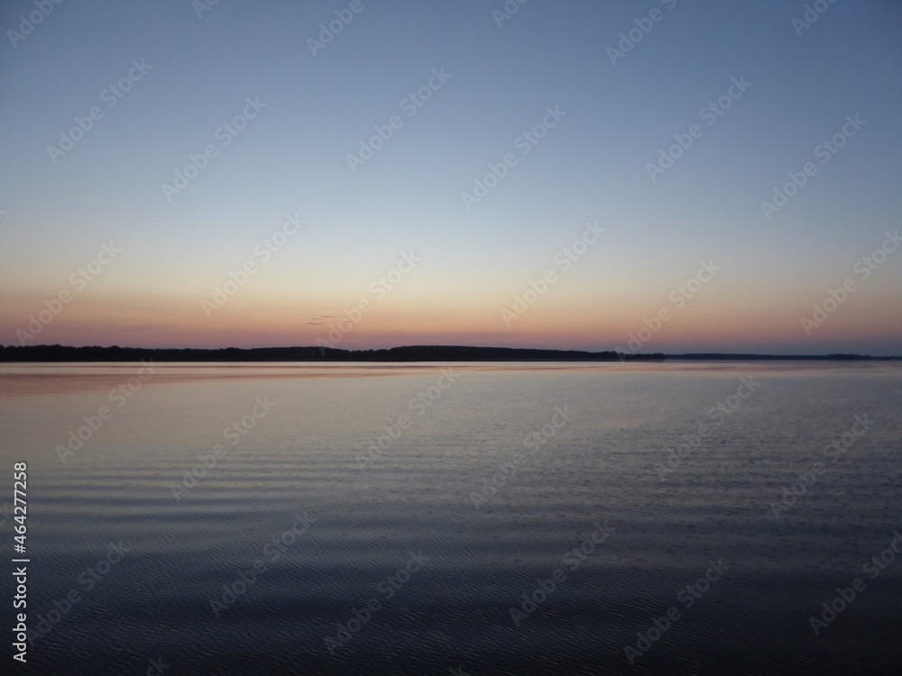 The calm surface of the Mueritz in the Mueritz National Park Mecklenburg-Western Pomerania, Germany in the evening