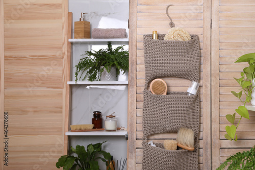 Shelving unit and organizer with essentials in bathroom. Stylish accessory
