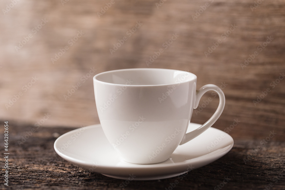white small ceramic espresso coffee or tea cup on wood background vintage tone white small ceramic espresso coffee or tea cup on wood background vintage tone