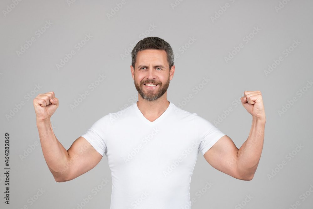 I am strong. Strong man grey background. Fit guy show strength. Muscle flexing. Physical fitness