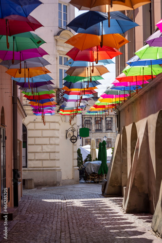 Tarnow  Poland - July 24  2021  Piekarska street near Town Square decorated with colorful umbrellas  modeled on the Portuguese  Umbrella Sky  design.