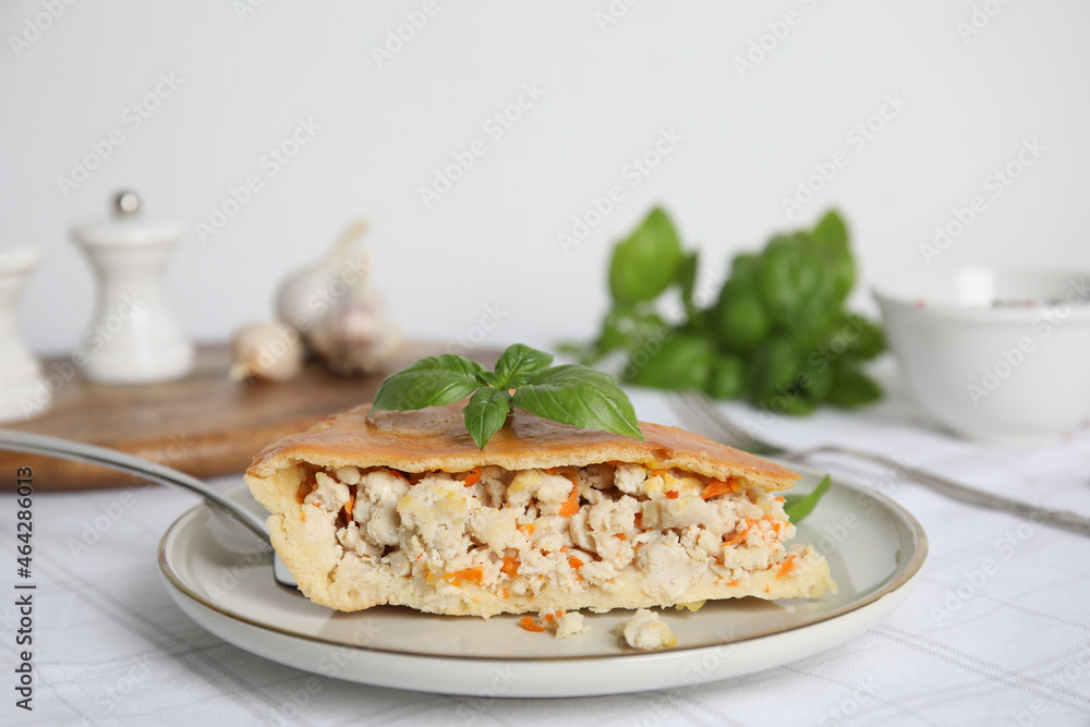 Slice of delicious meat pie with basil on table, space for text Slice of delicious meat pie with basil on table, space for text