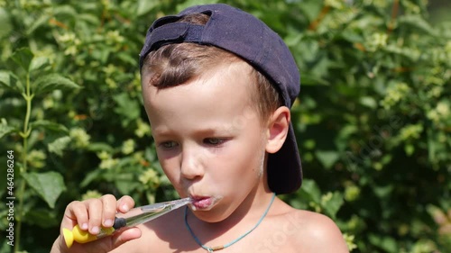 Wallpaper Mural Little boy learns to brush his teeth correctly in summer garden
 Torontodigital.ca