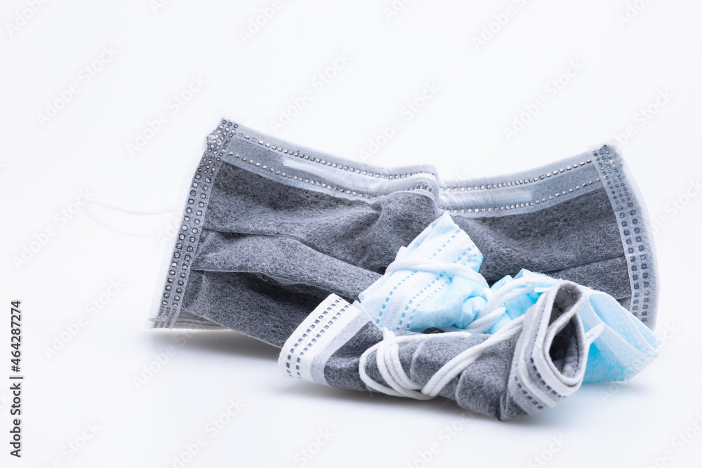 The medical disposable mask is isolated on white background with copy space. The medical disposable mask is isolated on white background with copy space.