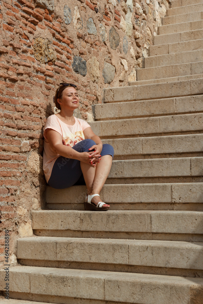 Woman sitting on the staircase Woman sitting on the staircase