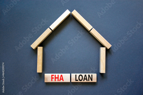 FHA federal housing administration loan symbol. Concept words 'FHA federal housing administration loan' on wooden blocks on a beautiful grey background. Business and FHA loan concept. Copy space.