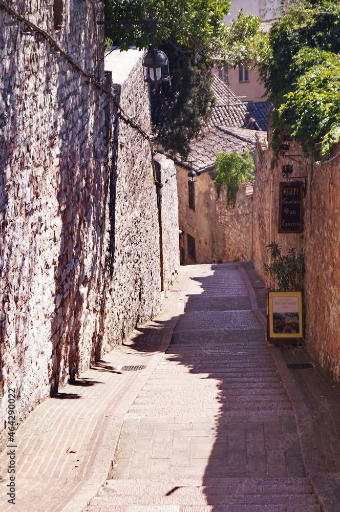 Typical alley with staircase in the medieval old town of Assisi, Italy