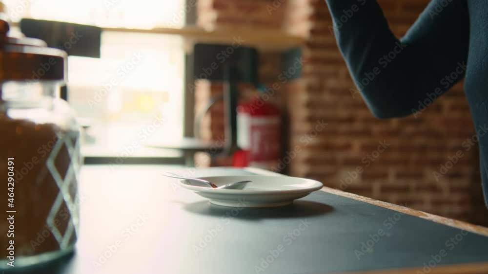 Female hand take cup of steaming coffee from table and take a sip. Young woman in cafe or restaurant drink americano or filter coffee from red mug. Cinematic breakfast footage Female hand take cup of steaming coffee from table and take a sip. Young woman in cafe or restaurant drink americano or filter coffee from red mug. Cinematic breakfast footage